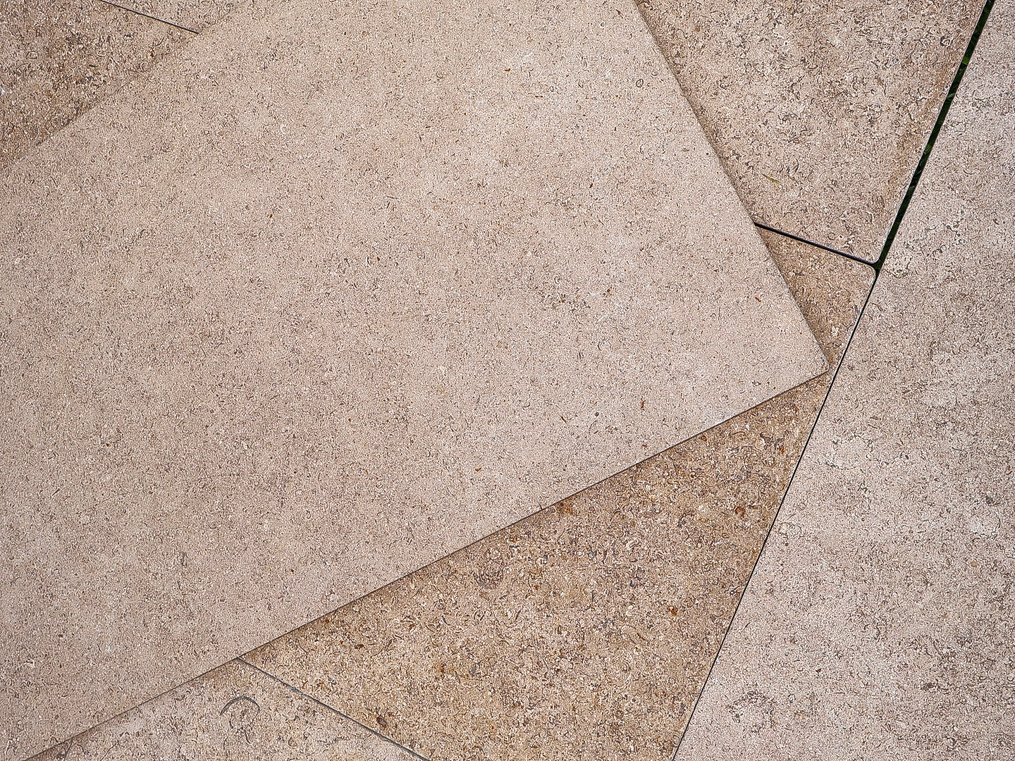 Close-up of beige stone tiles with a slight texture